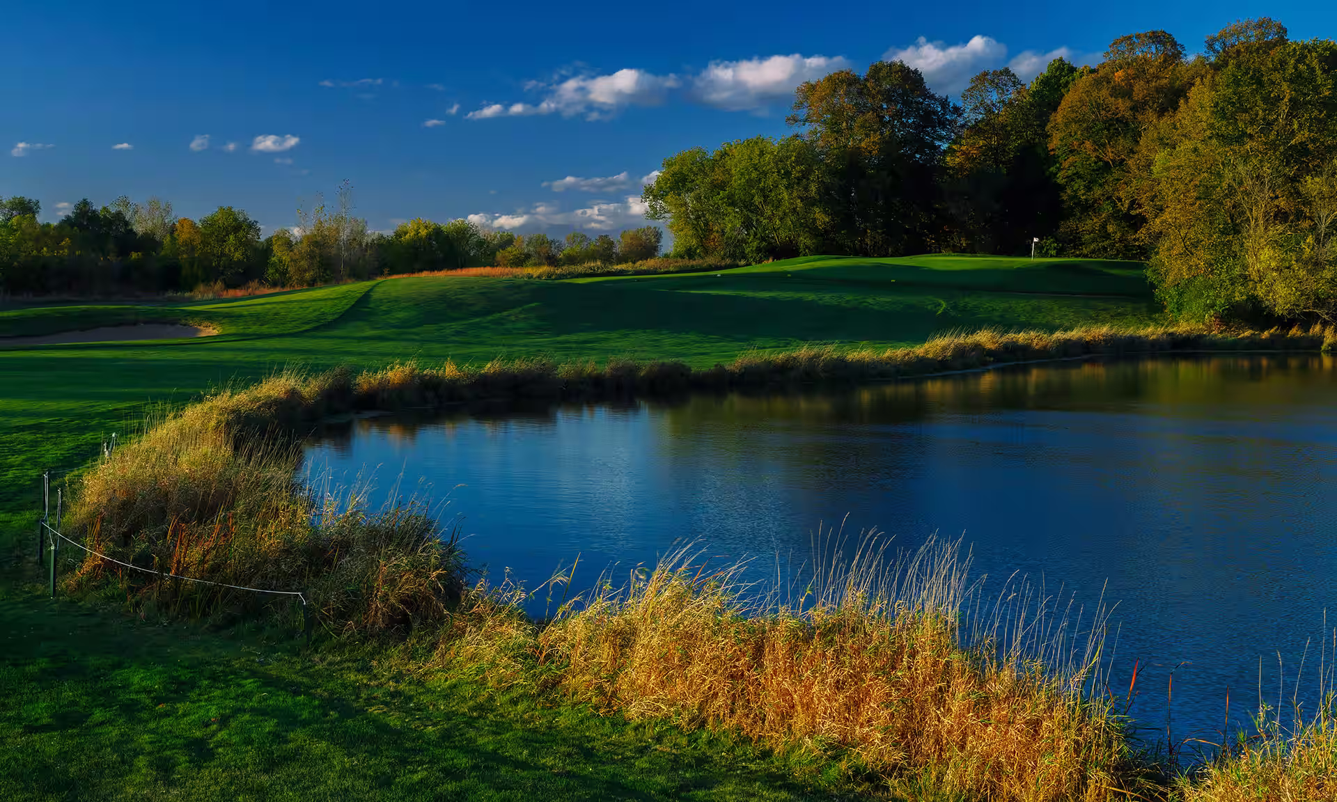 Beautiful deep blue pond reflecting skies at the Fire Ridge Golf Course
