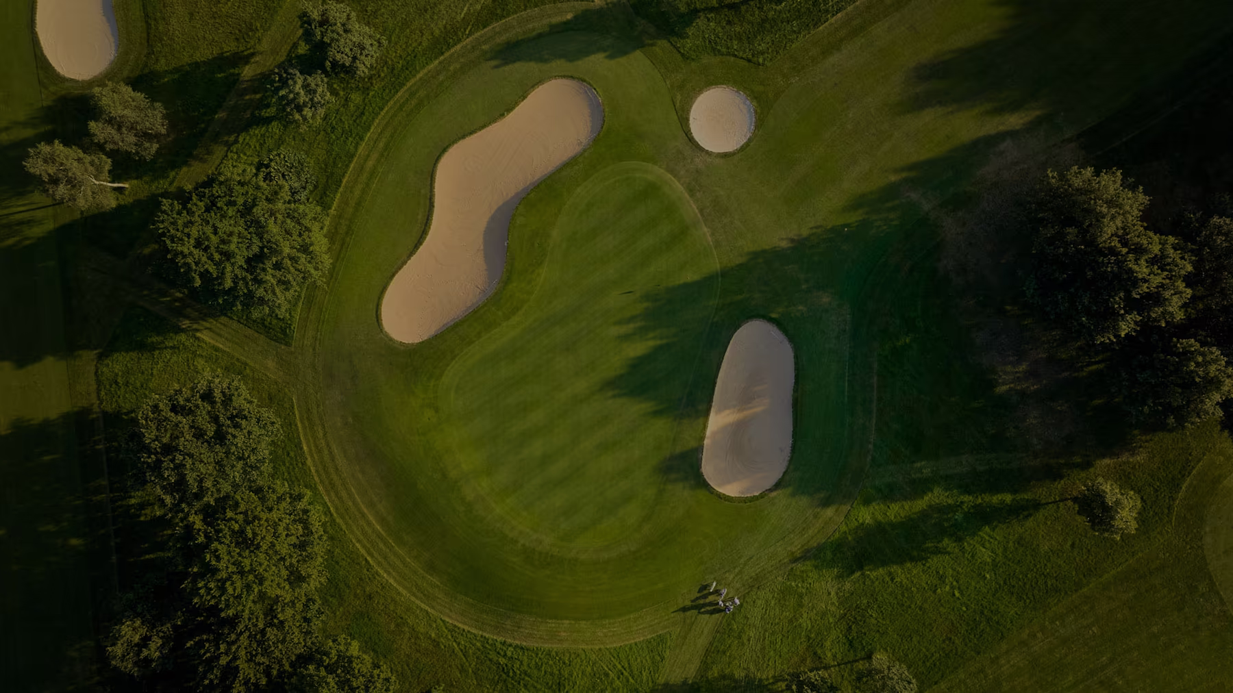 Bird's eye view of a wonderfully kept green and sand traps surrounding hole at Fire Ridge golf course