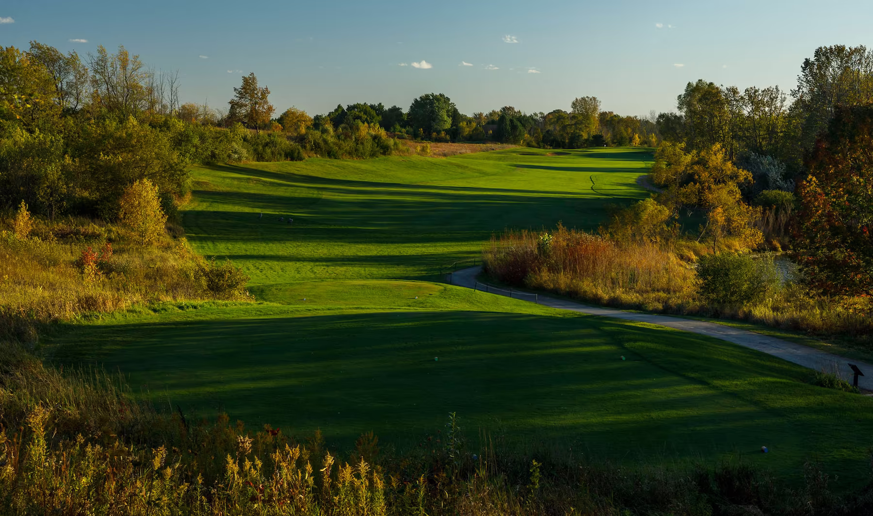 Golden hour sunset over the green and manicured fairways at Fire Ridge Golf Club in Grafton, Wisconsin.